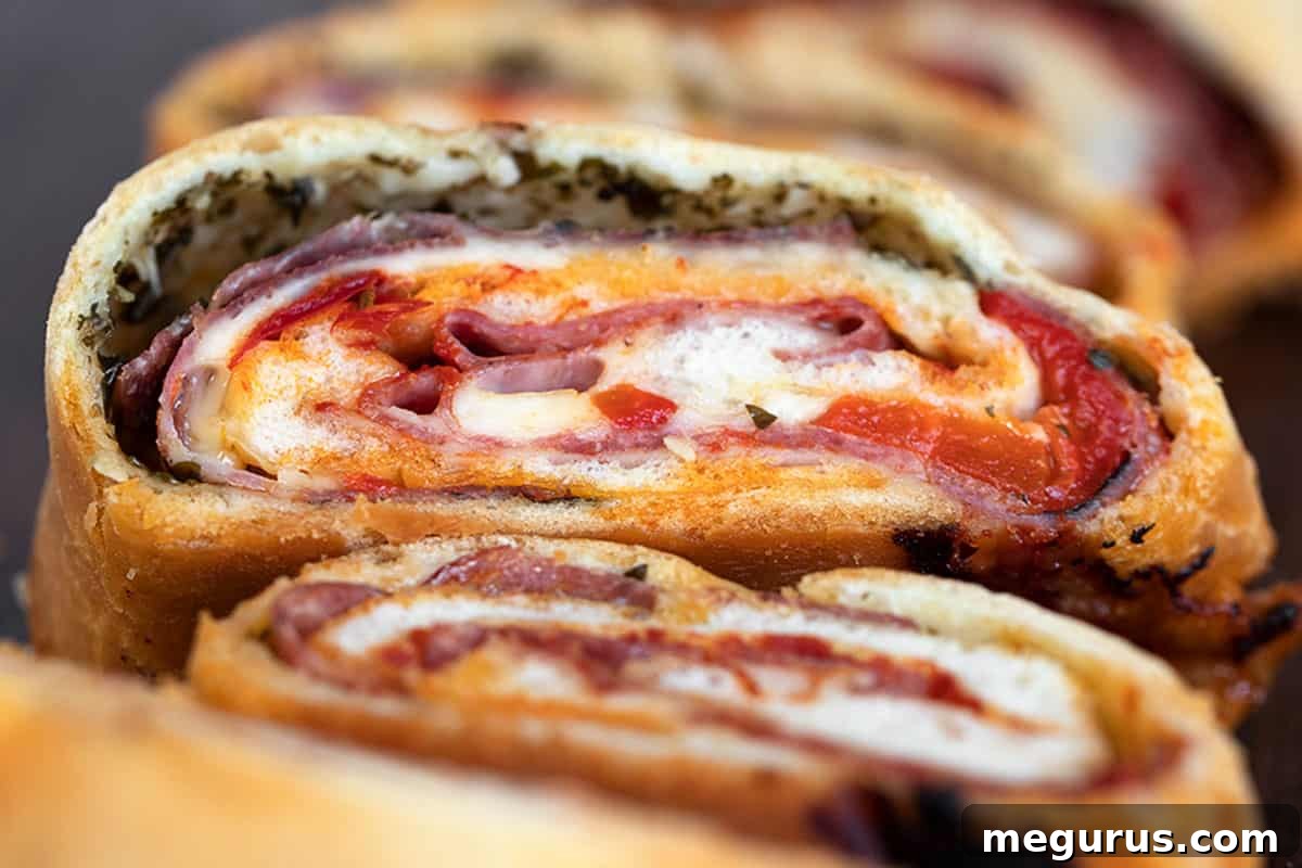 A freshly baked classic stromboli, perfectly sliced on a rustic cutting board, showcasing its rich, savory fillings.