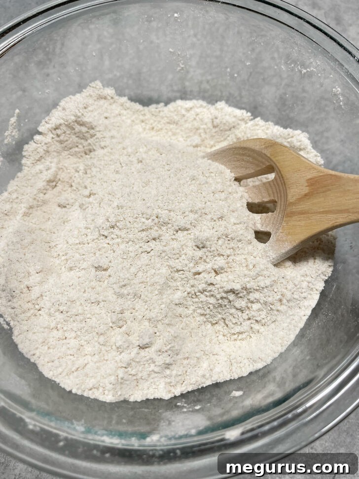 Dry ingredients for banana muffin batter mixed in a medium bowl.