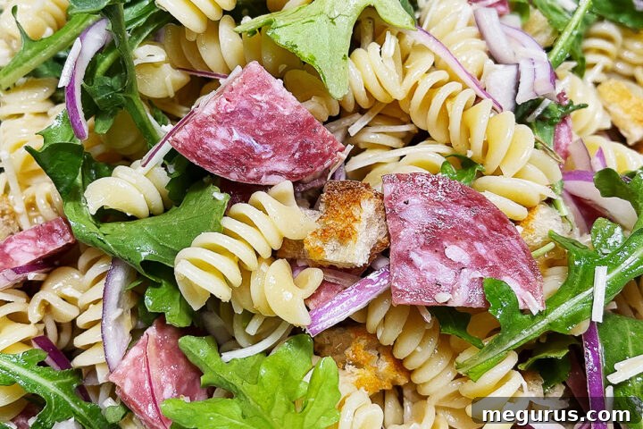 Pasta salad with salami in a bowl.