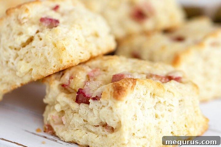 Beautifully arranged rhubarb scones on a white serving board, ready to be enjoyed.