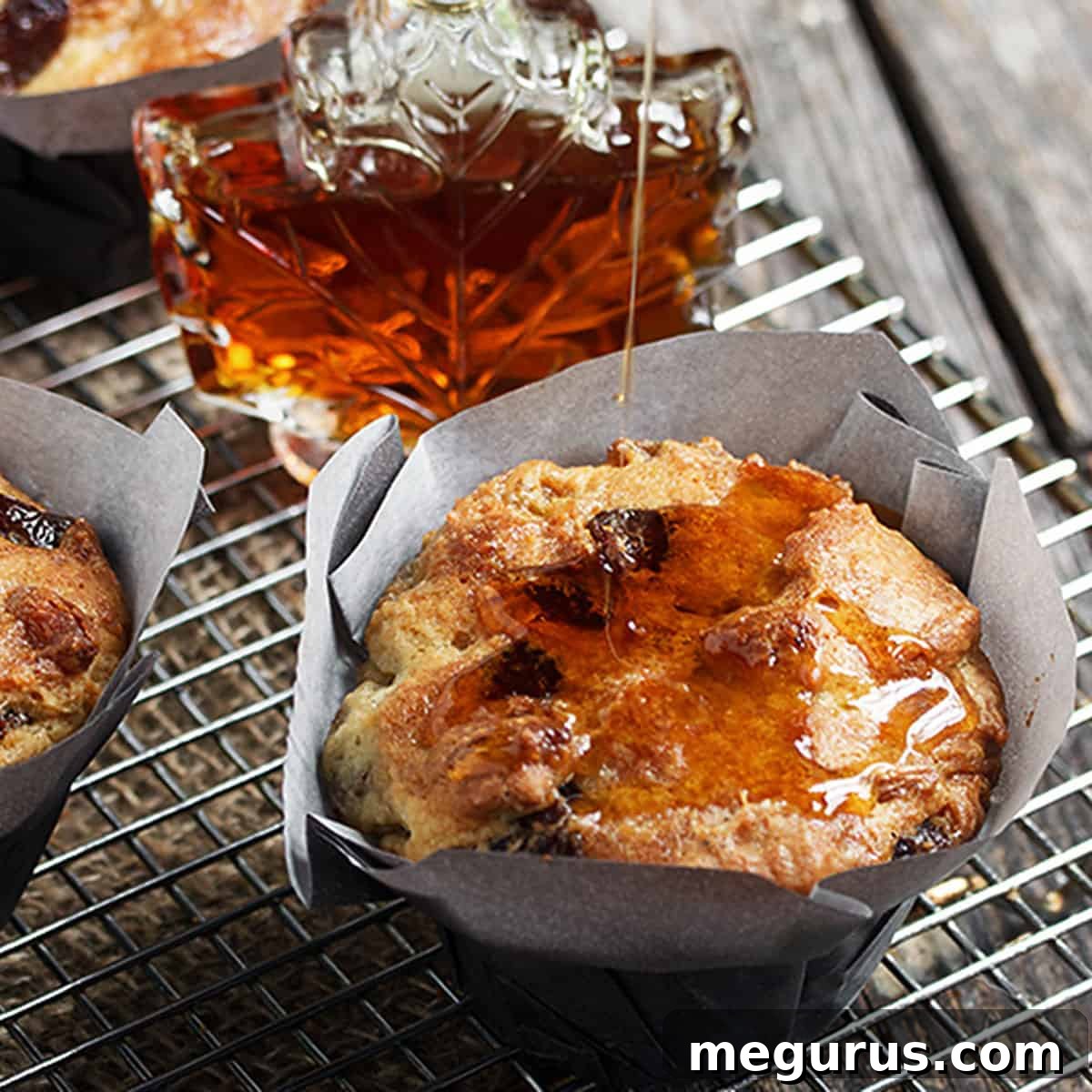butter tart muffins on cooling rack with maple syrup bottle