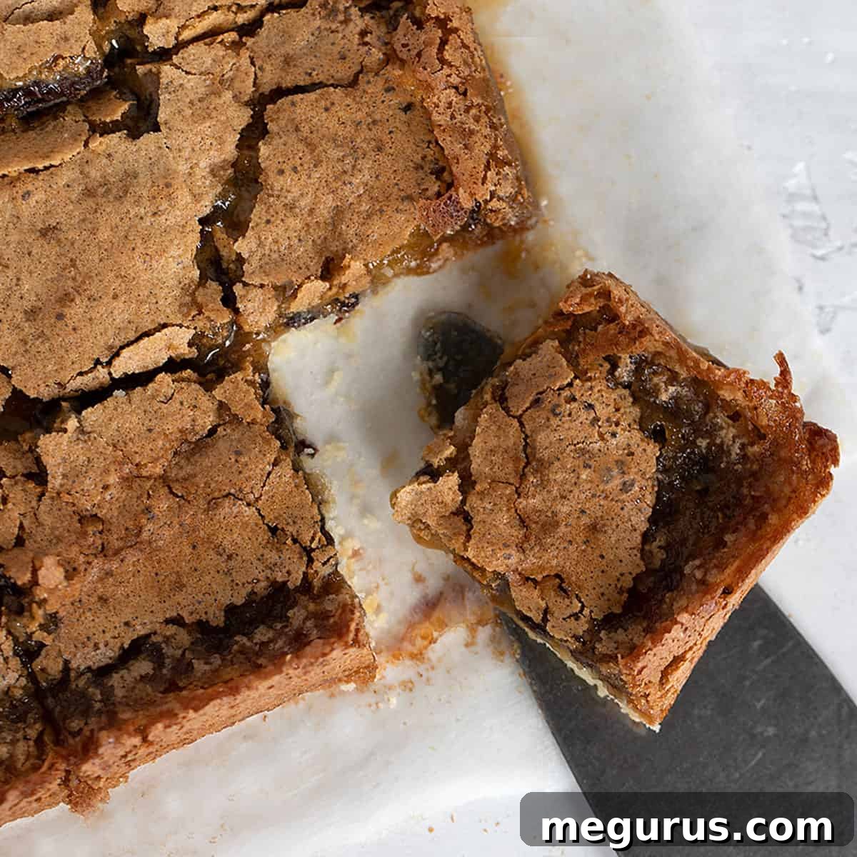 butter tart squares cut on parchment paper