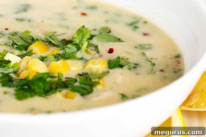 chicken corn coconut soup in white bowl