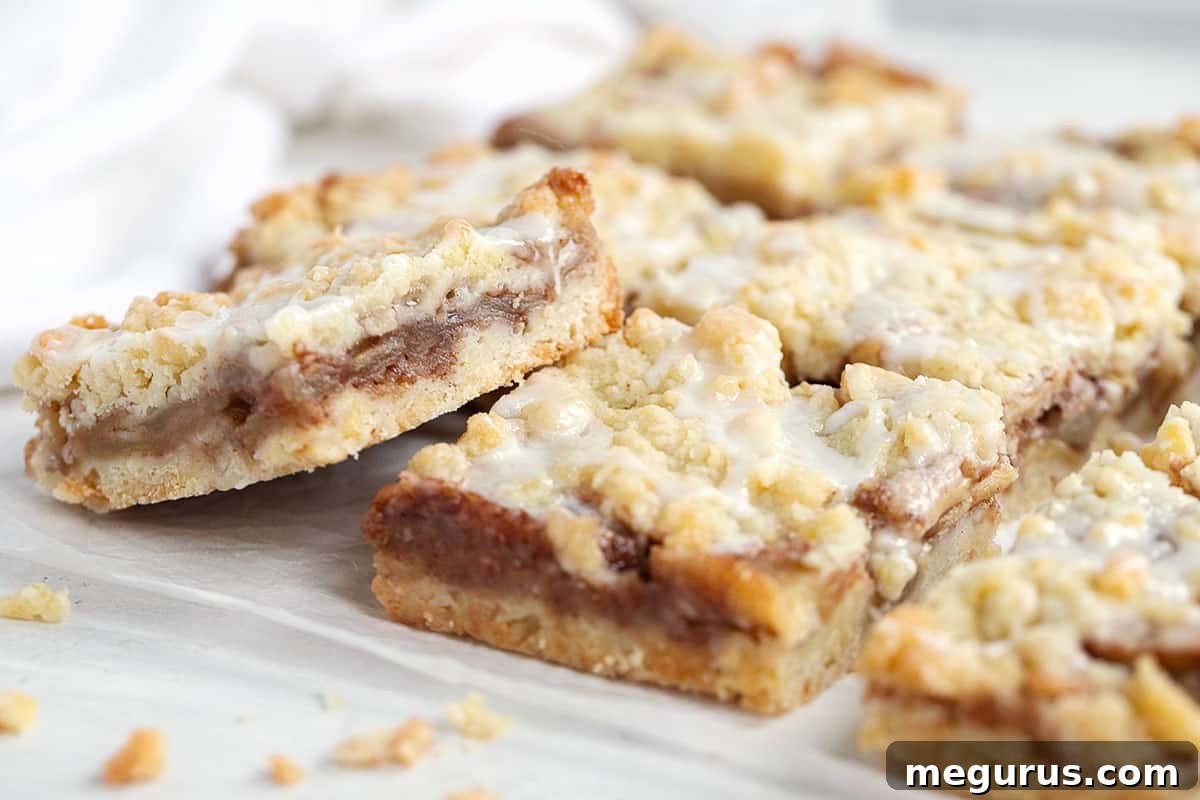 Delicious apple streusel bars arranged neatly on parchment paper, ready to be served.