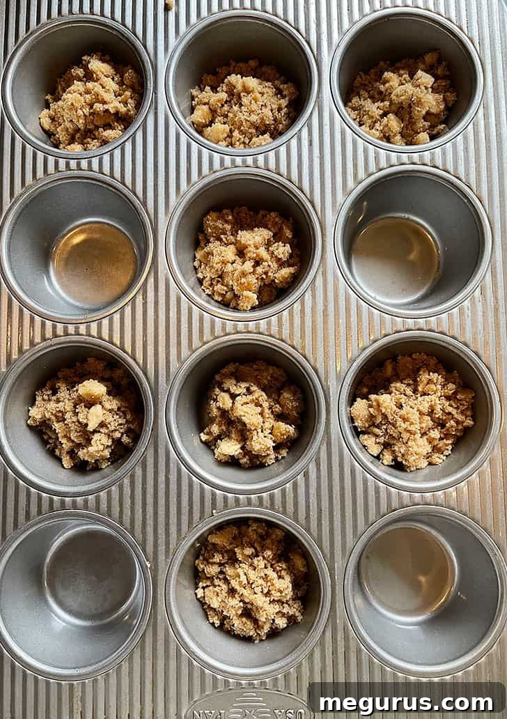 Brown sugar, cinnamon, and butter mixture prepared in muffin cups