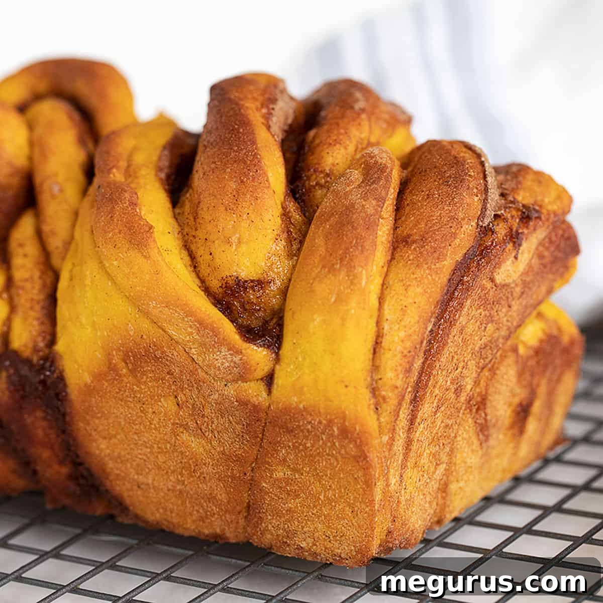 cinnamon swirl pumpkin yeast bread on cooling rack