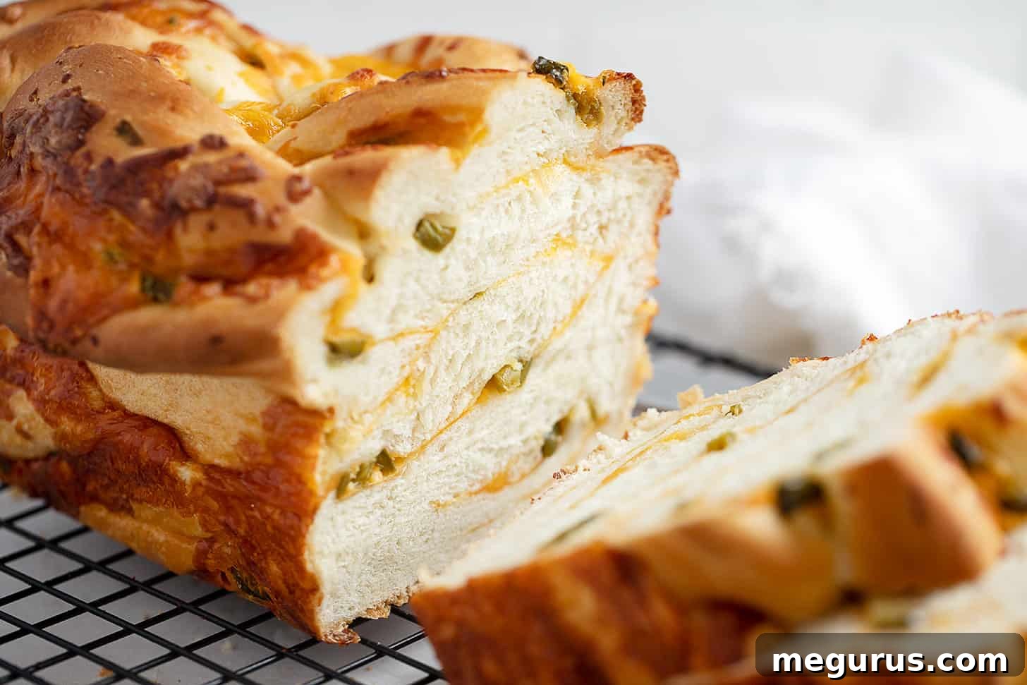 jalapeño cheese bread sliced on cooling rack