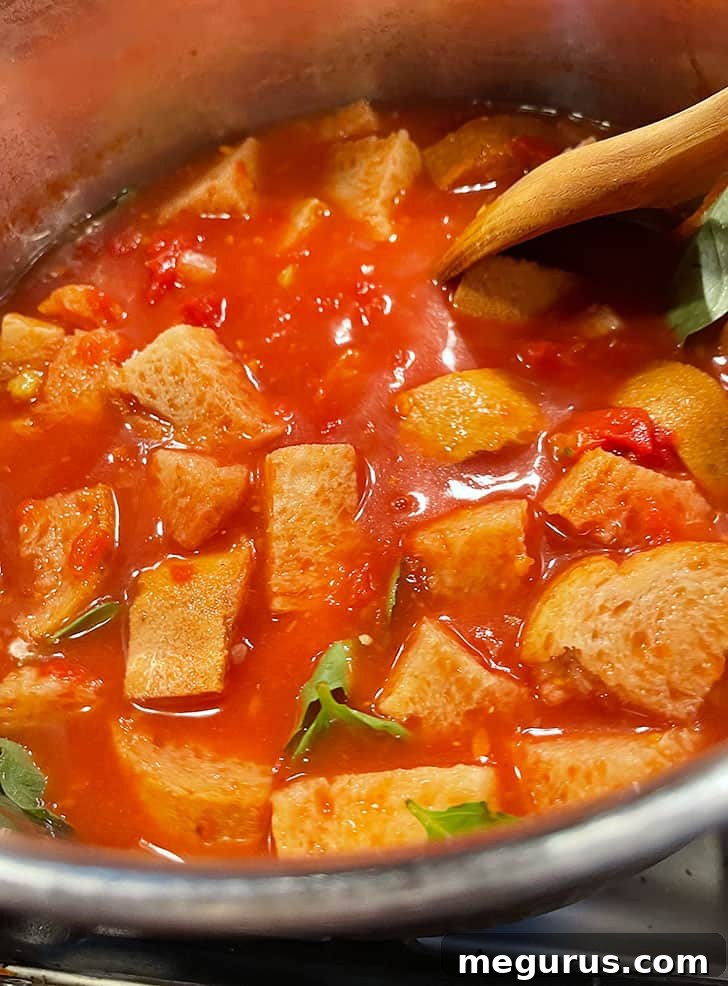 The Pappa al Pomodoro gently simmering in a pot, with flavors melding together.