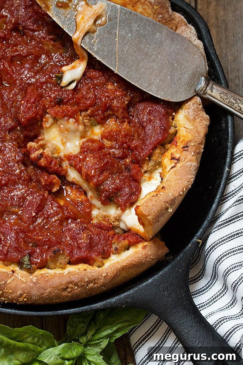 Close-up of Chicago deep dish pizza slices showing rich melted cheese and savory sausage
