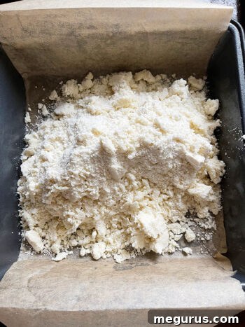 crumb mixture poured into parchment-lined baking pan