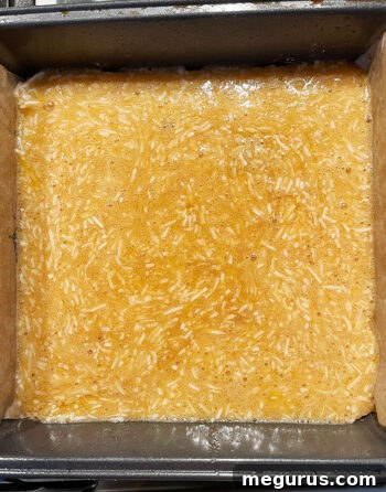 topping mixture poured over par-baked base in baking pan