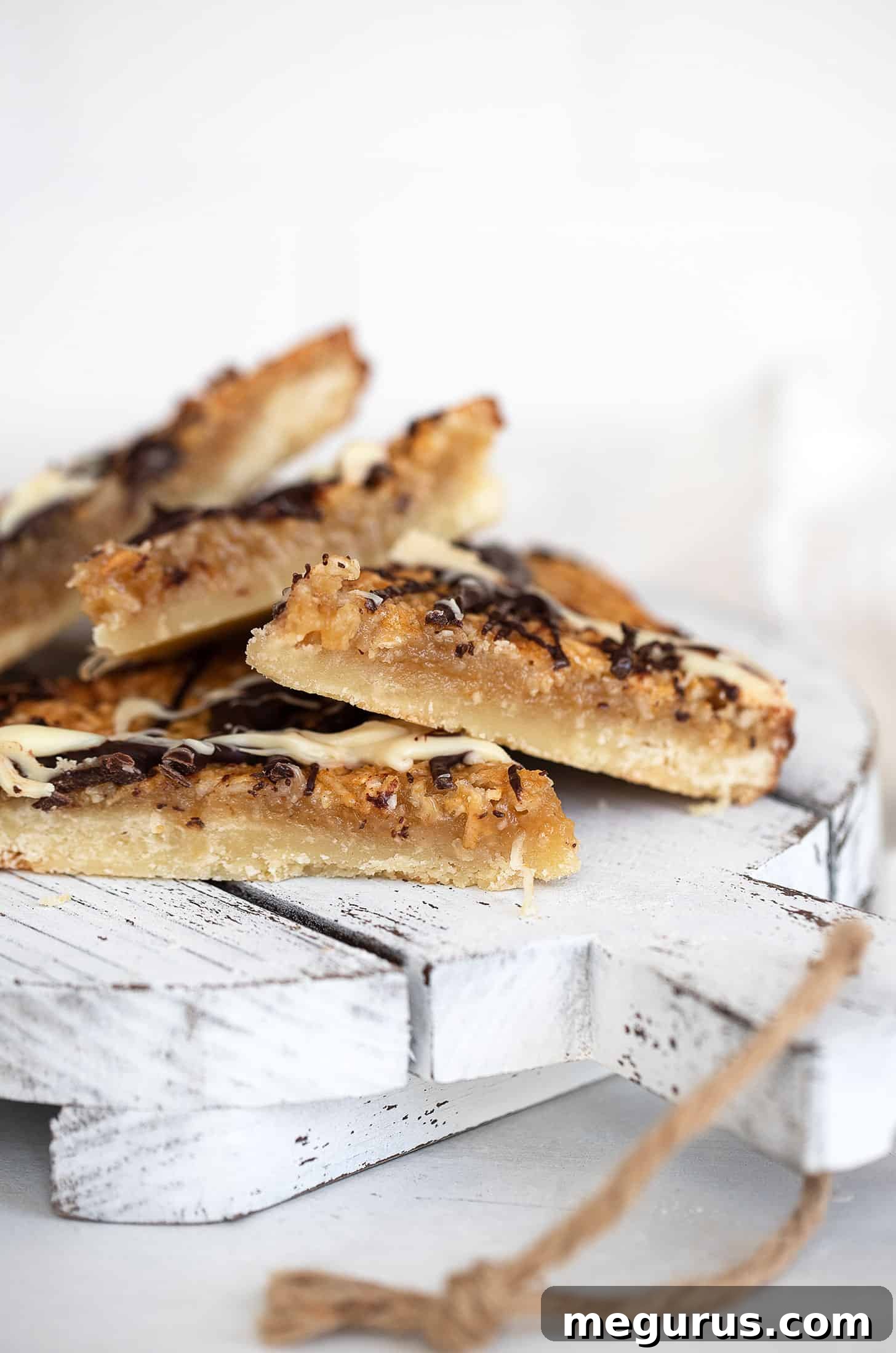 macaroon madness bars arranged attractively on a wooden serving board