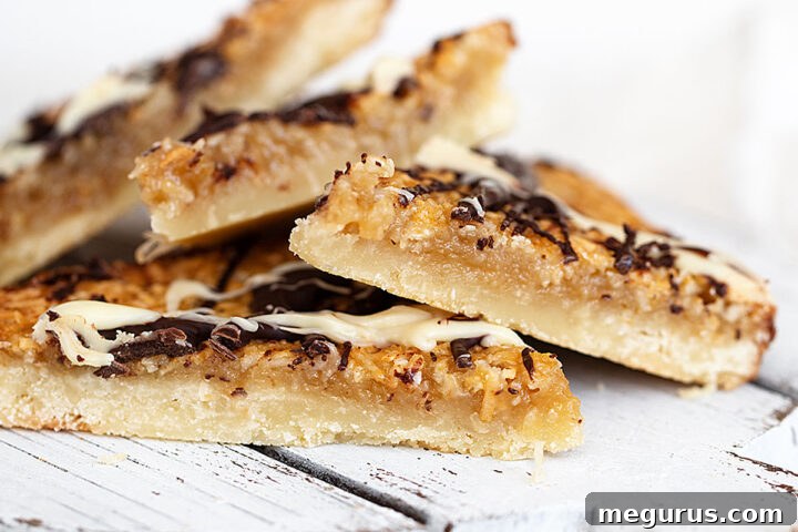 close-up of Macaroon Madness Bars, highlighting the texture and chocolate drizzle