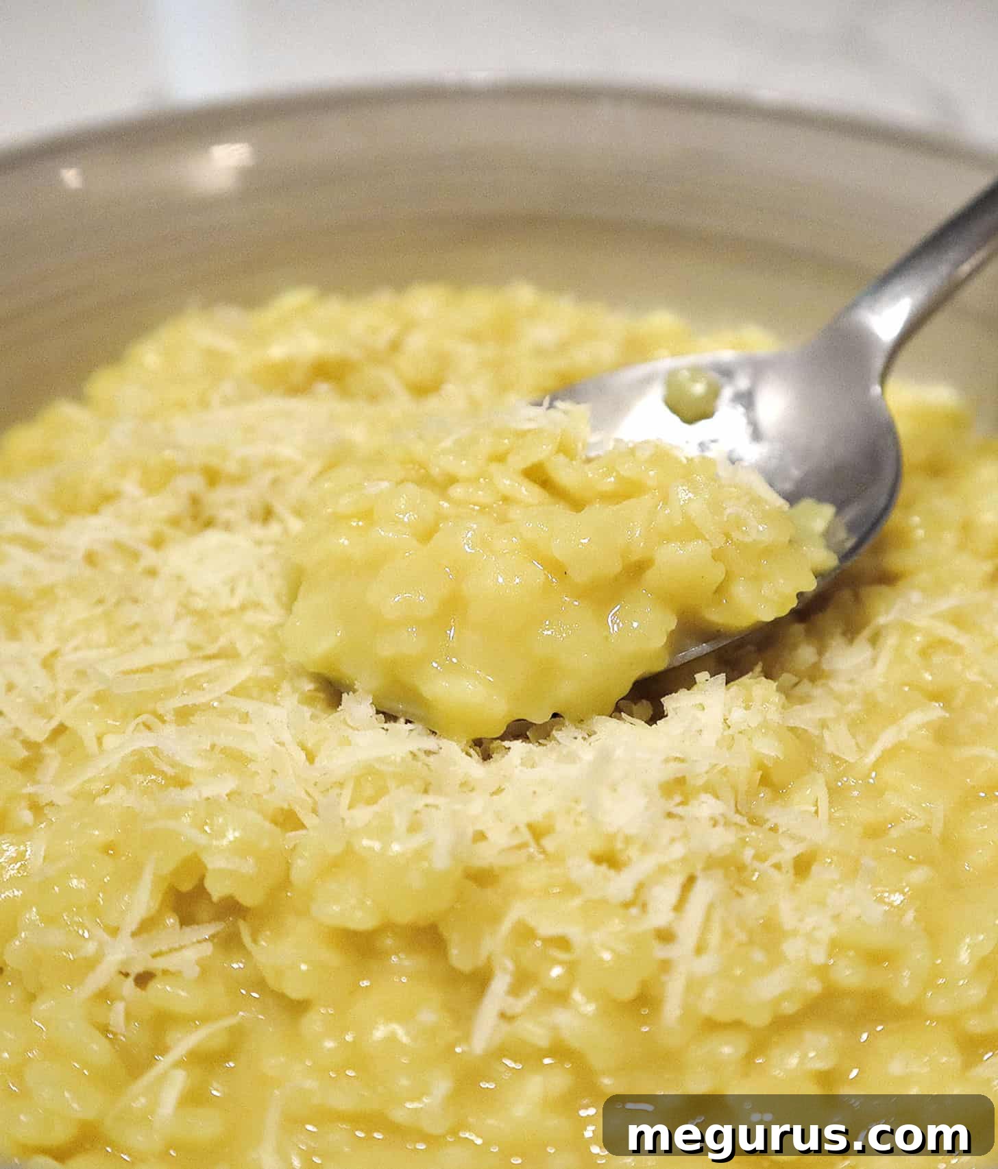 pastina with egg and cheese in bowl with spoon