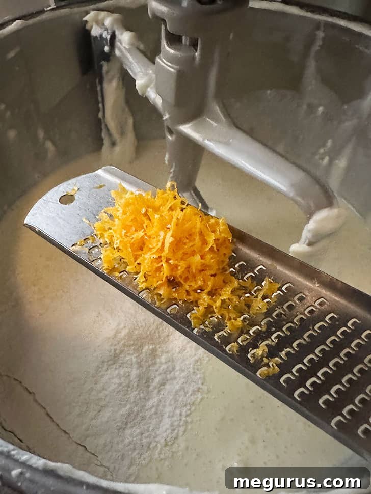 Adding fresh lemon zest to the cheesecake mixture for flavor.