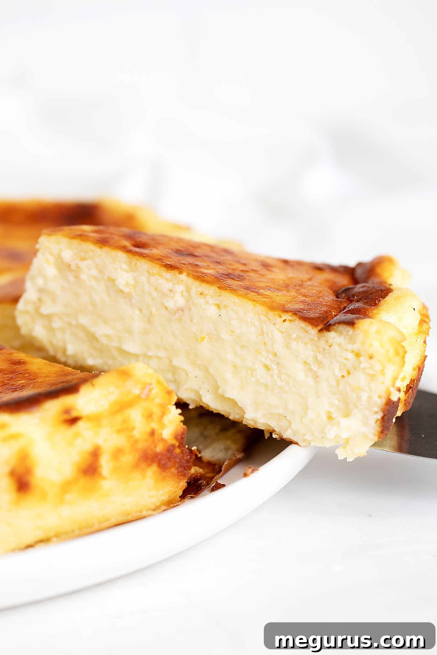 Another beautiful slice of lemon Basque cheesecake, highlighting its smooth interior and caramelized crust.