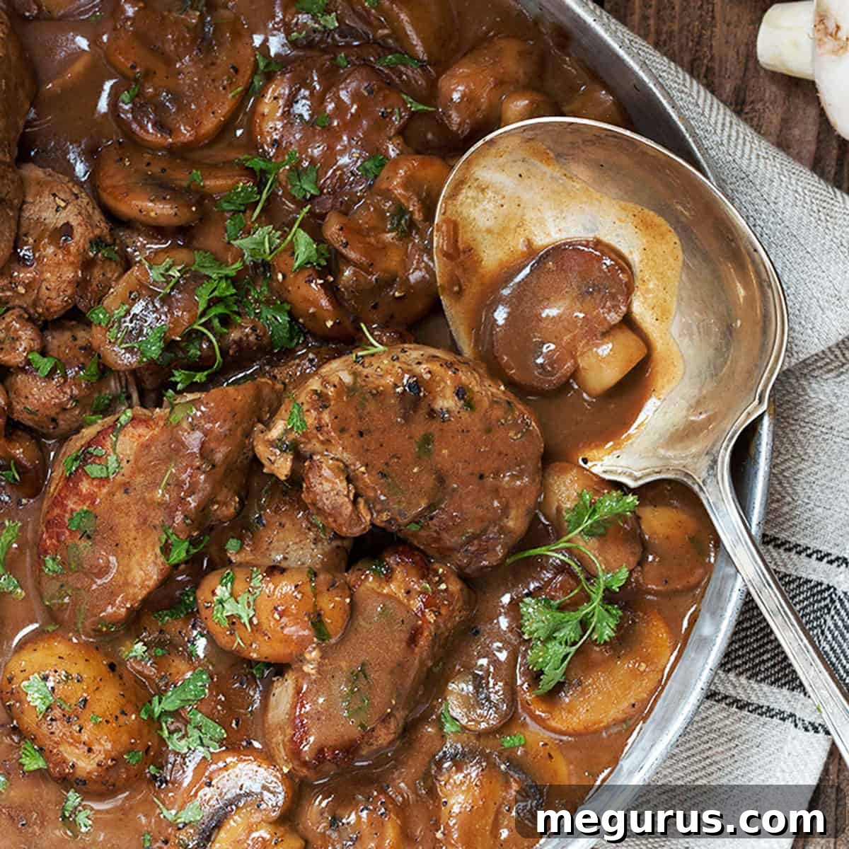 Pork medallions with mushrooms and marsala sauce in pan
