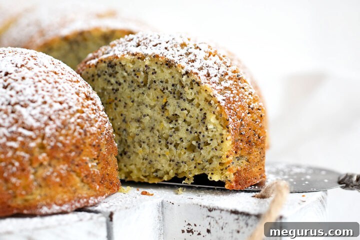 Sliced Orange Poppy Seed Bundt Cake on a white board