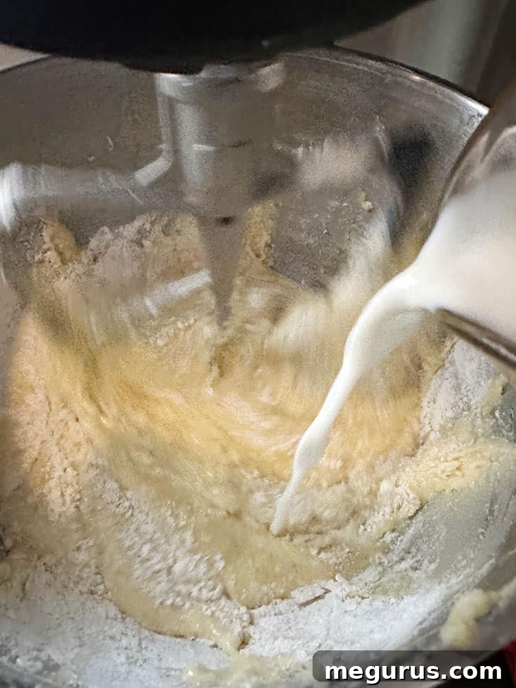 Mixing in the milk and poppy seed mixture.