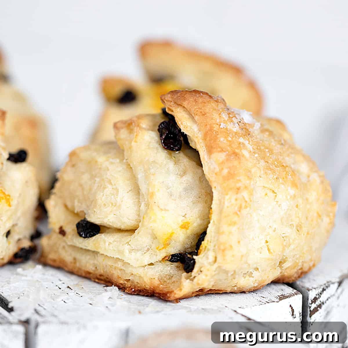 Fluffy Irish scones studded with currants, served on a platter ready for clotted cream and jam.
