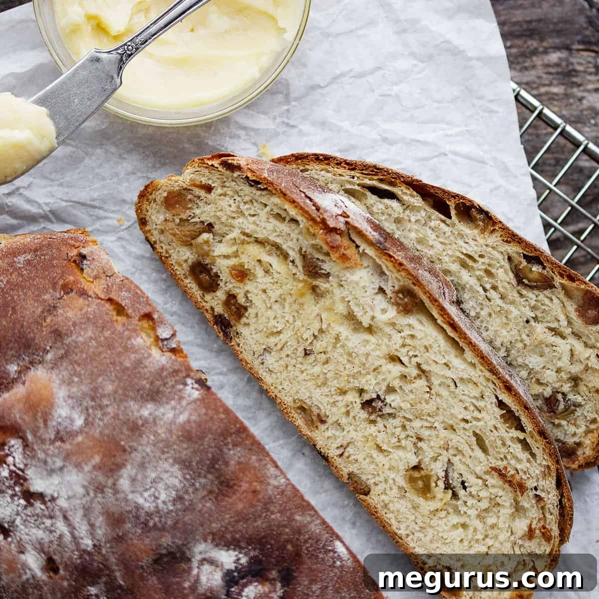 Slices of Traditional Irish Barmbrack Bread, with tea-soaked raisins visible, served with honey butter.