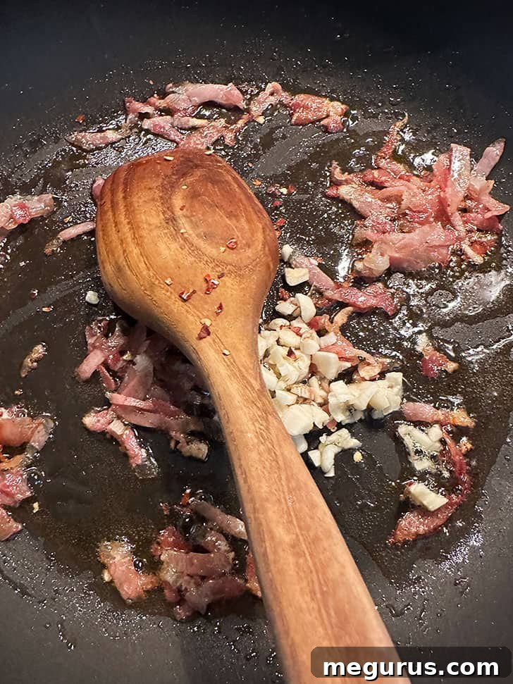 skillet with browned pancetta, garlic and red pepper flakes