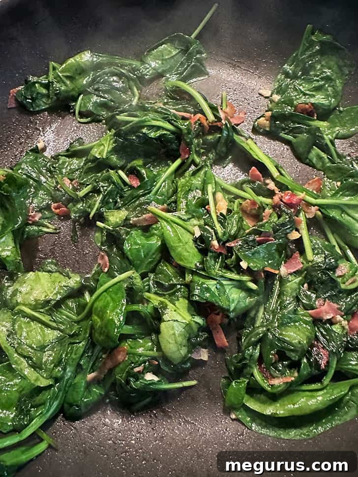 skillet after adding spinach and wilting