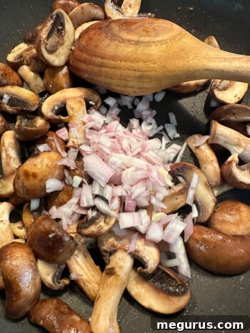 Diced shallots added to sautéing mushrooms in the pan
