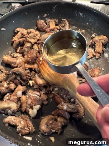 Deglazing the pan with white wine after sautéing vegetables