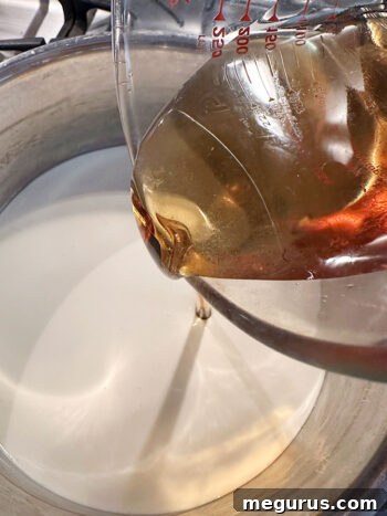 Adding maple syrup to cream in a saucepan to heat