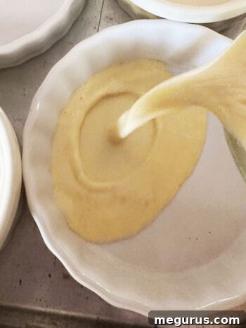 Pouring custard into ramekins before baking