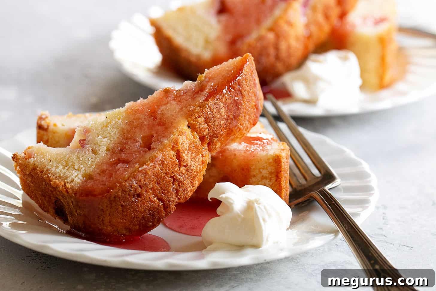 Beautifully plated rhubarb loaf cake with rhubarb syrup, ready to be served as a delightful dessert.