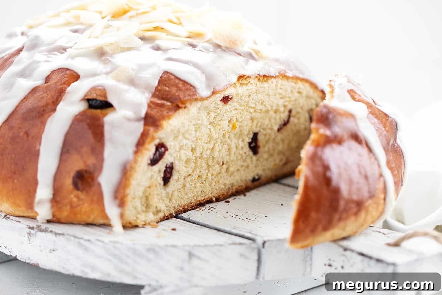 Freshly baked cranberry orange yeast bread, perfectly sliced on a cutting board, revealing its tender crumb.