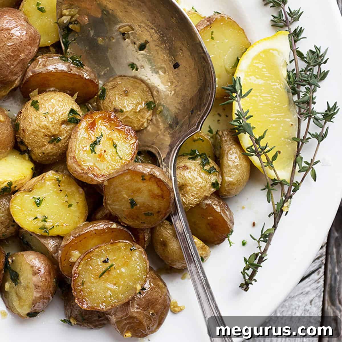 lemon garlic potatoes in white bowl with spoon