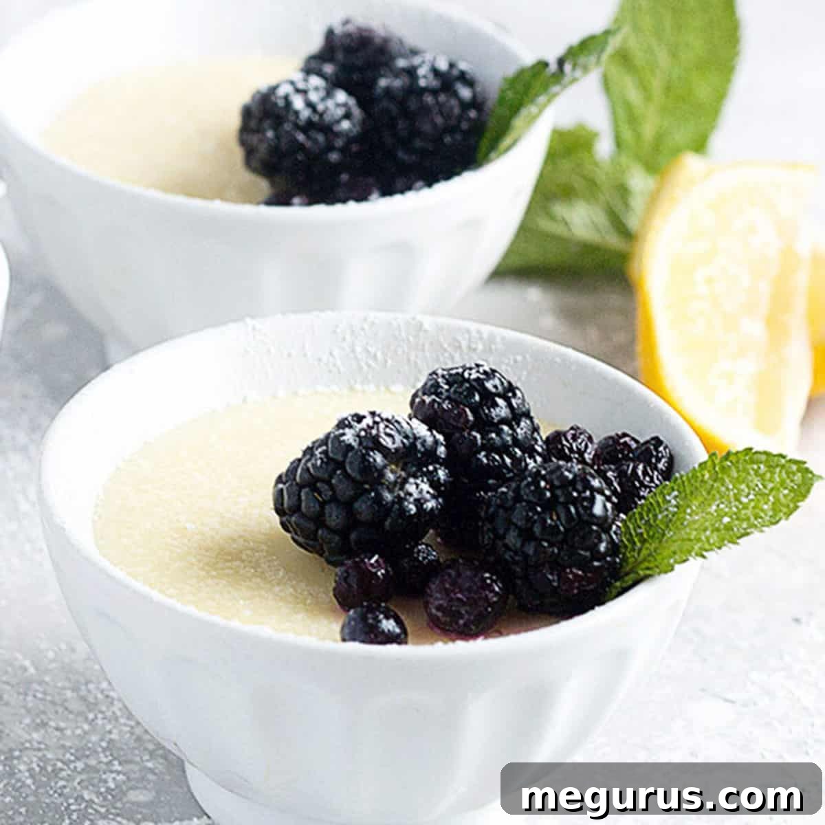 lemon posset in small white bowls with berries on top