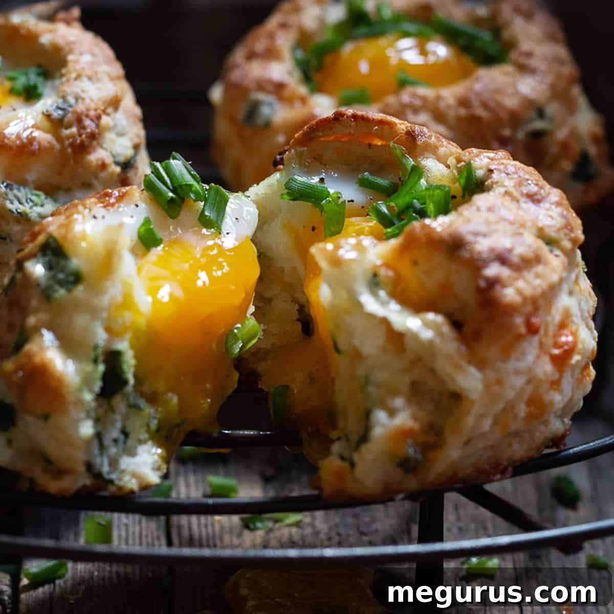 buttermilk biscuits with egg baked on top on cooling rack