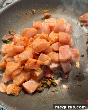 adding chicken to skillet