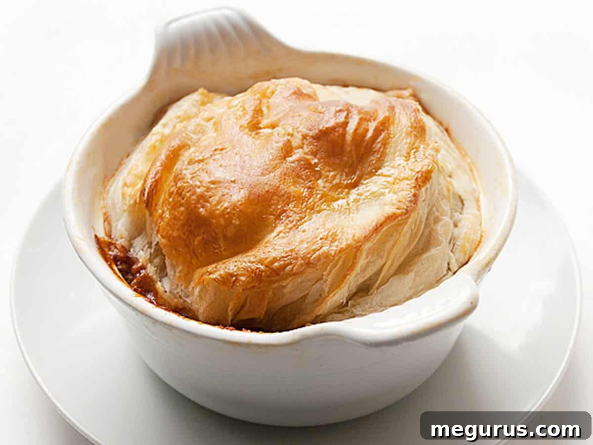 Hearty Beef and Guinness Pie with Golden Puff Pastry Topping ready to be served