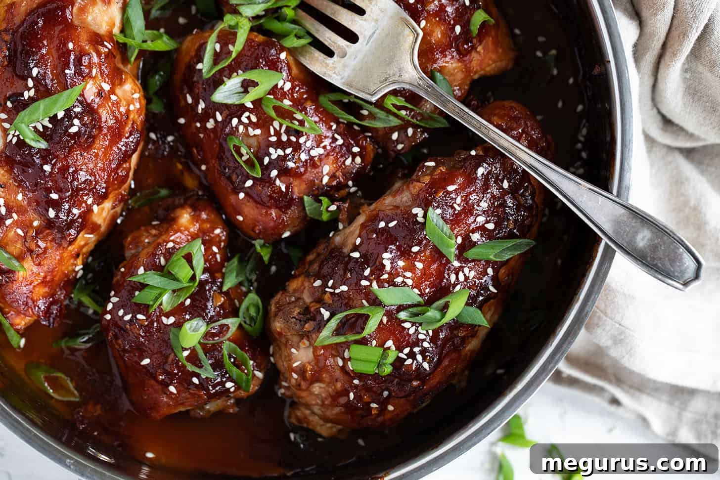 Irresistible sticky chicken in a baking dish, ready to be served.