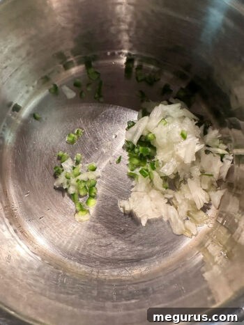 Diced onion and jalapeño added to a hot pan