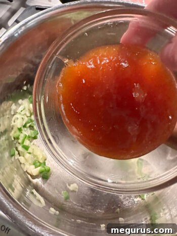 Mango chutney being added to the saucepan