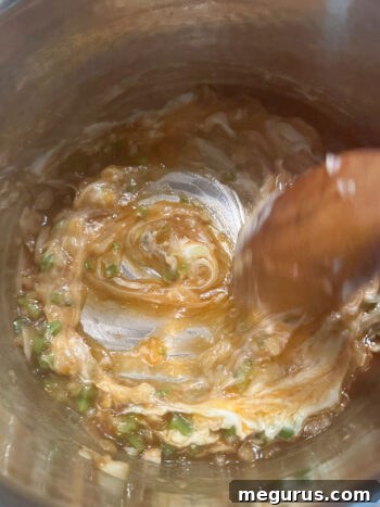 Sauce ingredients being stirred together in the pan