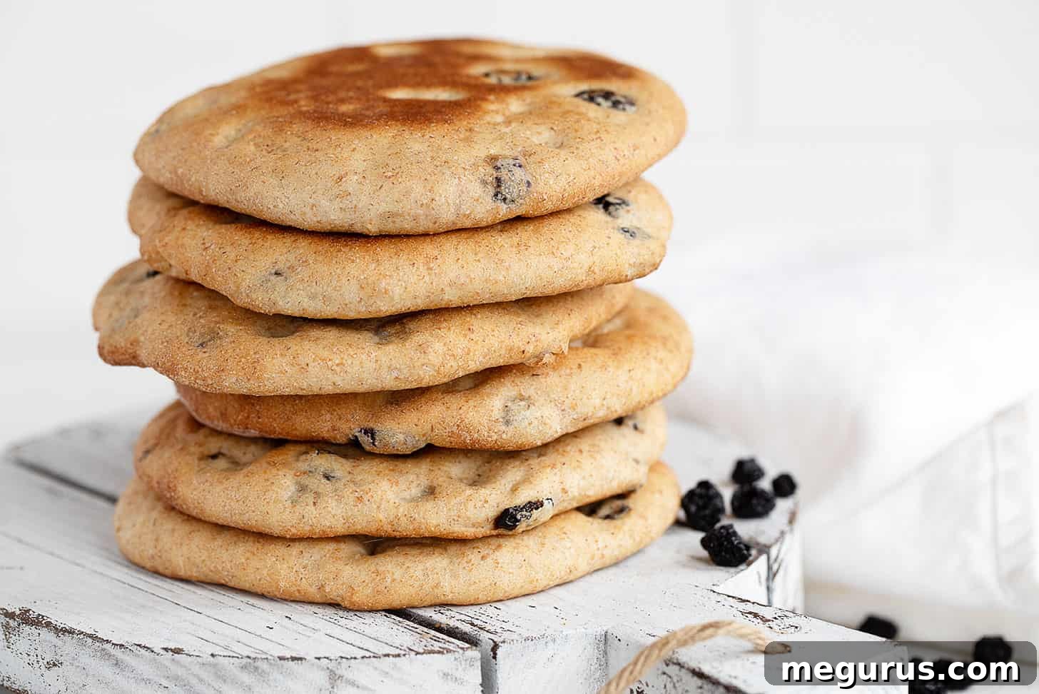 Stacked homemade blueberry breakfast rounds, golden brown and inviting.