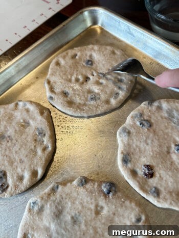 Dough rounds being pricked with a fork (