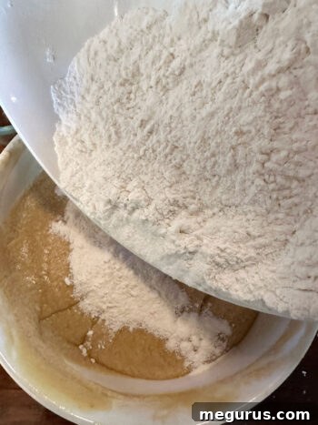 Adding dry flour mixture to the wet blondie batter