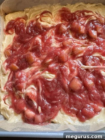 Using a skewer to swirl rhubarb compote into blondie batter