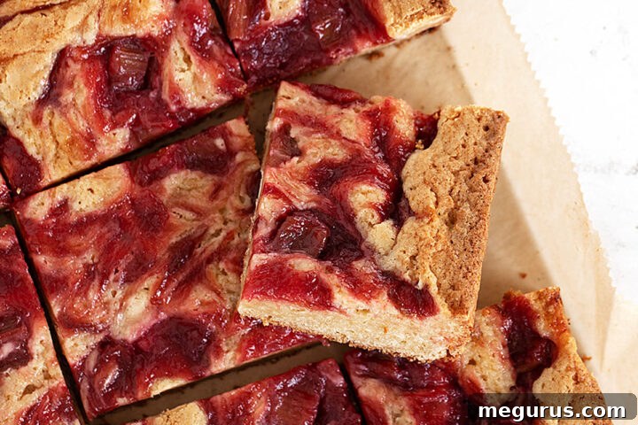 rhubarb blondies cut on parchment paper