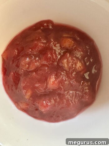 Rhubarb compote transferred to a bowl for cooling