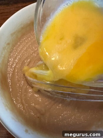 Adding beaten eggs to the blondie batter
