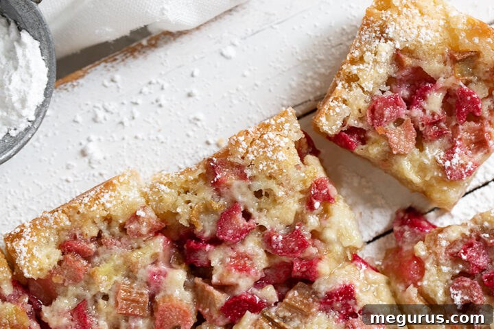 Old-fashioned rhubarb bars, perfectly baked and sliced on a serving board.